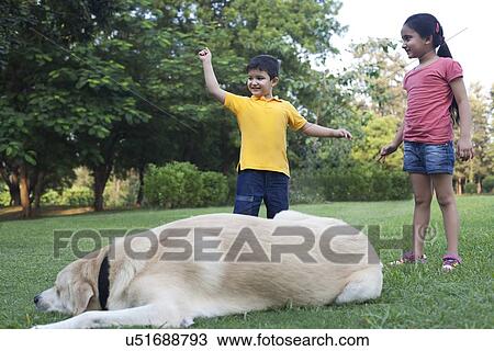 Stock Image - Children enjoying in a park. Fotosearch