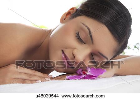 Picture - Close-up of a beautiful young lady relaxing at spa . Fotosearch
