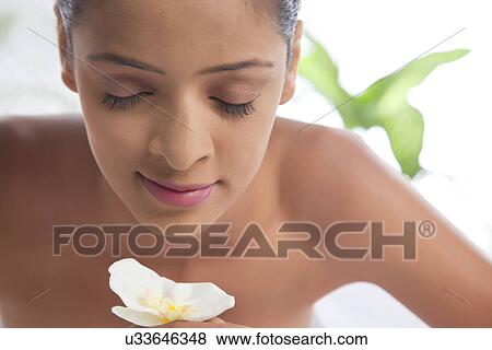 Stock Photo - Close-up of an attractive woman with eyes closed at spa . Fotosearch