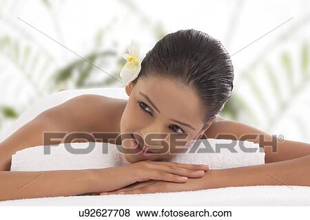 Stock Photo - Close-up of pretty woman looking away at spa . Fotosearch