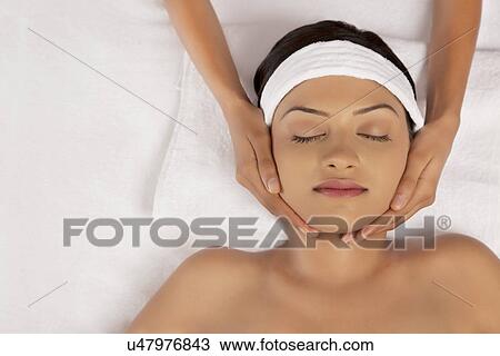 Stock Image - Close-up of woman getting face massage . Fotosearch