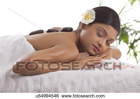 Close-up of woman getting hot stone treatment View Large Photo Image Stock Photograph - Close-up of woman getting hot stone treatment . Fotosearch
