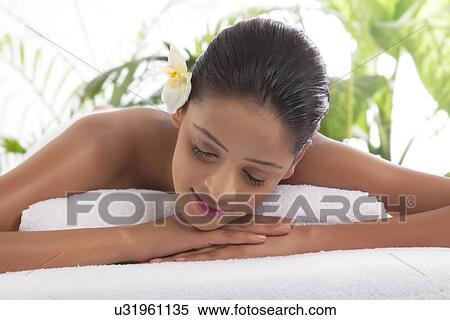 Close-up of woman with eyes closed at spa  View Large Photo Image Stock Photography - Close-up of woman with eyes closed at spa . Fotosearch