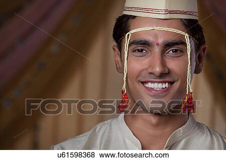 Stock Photo - Close-up of young Maharashtrian groom smiling . Fotosearch