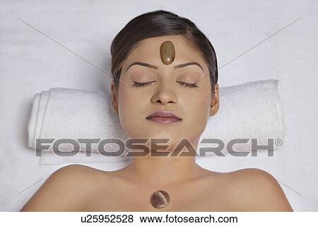 Close-up of young woman getting hot stone treatment View Large Photo Image Stock Photo - Close-up of young woman getting hot stone treatment . Fotosearch