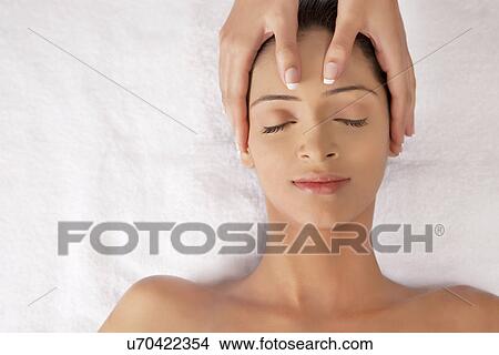Picture - Close-up of young woman having head massage . Fotosearch