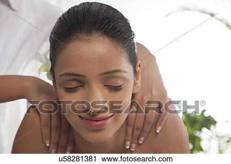 Close-up of young woman receiving shoulder massage View Large Photo Image Stock Image - Close-up of young woman receiving shoulder massage . Fotosearch