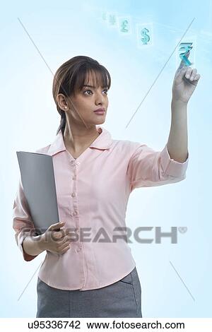 Confident young businesswoman using hi-tech computer monitor View Large Photo Image Stock Image - Confident young businesswoman using hi-tech computer monitor . Fotosearch