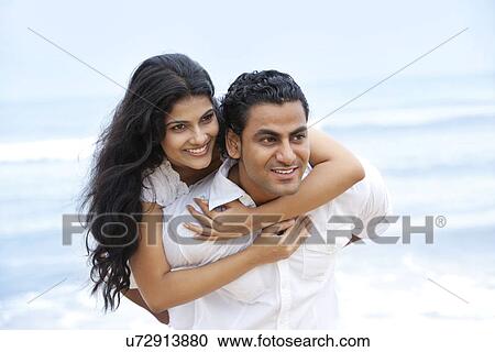 Couple having fun at a beach View Large Photo Image Stock Image - Couple having fun at a beach . Fotosearch