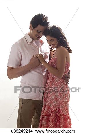 Couple holding each other while looking at ring View Large Photo Image Picture - Couple holding each other while looking at ring. Fotosearch