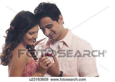 Couple looking at engagement ring View Large Photo Image Stock Photo - Couple looking at engagement ring. Fotosearch