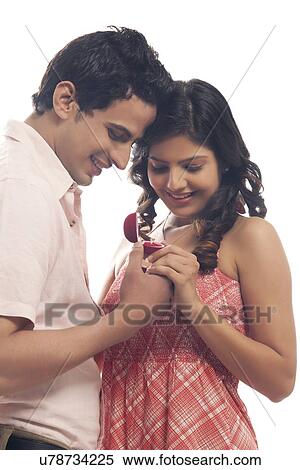Stock Photography - Couple looking at engagement ring. Fotosearch