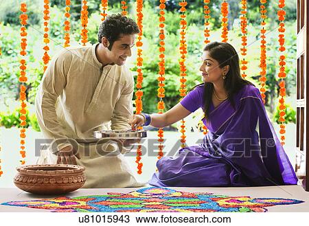 Couple making a rangoli  View Large Photo Image Stock Image - Couple making a rangoli . Fotosearch