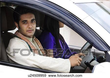 Couple sitting in a car View Large Photo Image Stock Photo - Couple sitting in a car . Fotosearch