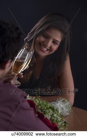 Stock Image - Couple toasting on Valentines Day. Fotosearch