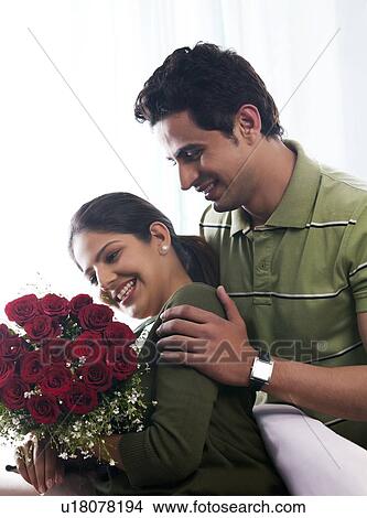 Picture - Couple with a bouquet of roses. Fotosearch
