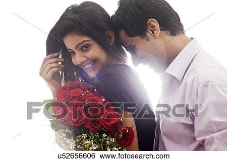 Couple with a bouquet of roses smiling View Large Photo Image Stock Photograph - Couple with a bouquet of roses smiling. Fotosearch