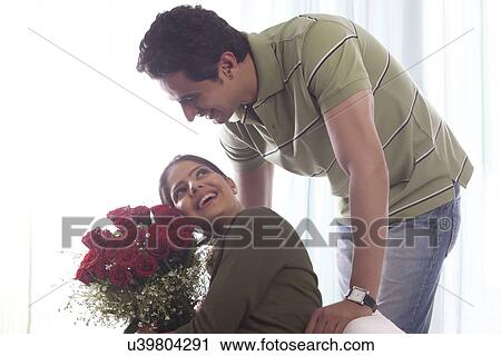 Couple with a bouquet of roses View Large Photo Image Stock Image - Couple with a bouquet of roses. Fotosearch