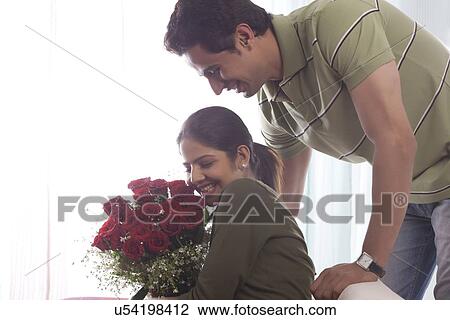 Couple with a bouquet of roses View Large Photo Image Stock Image - Couple with a bouquet of roses. Fotosearch