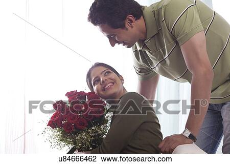 Couple with a bouquet of roses View Large Photo Image Stock Image - Couple with a bouquet of roses. Fotosearch