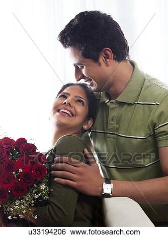 Stock Photograph - Couple with a bouquet of roses. Fotosearch