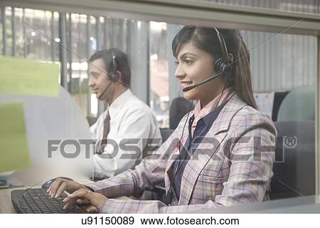Customer service representatives working on computers View Large Photo Image Stock Photo - Customer service representatives working on computers. Fotosearch