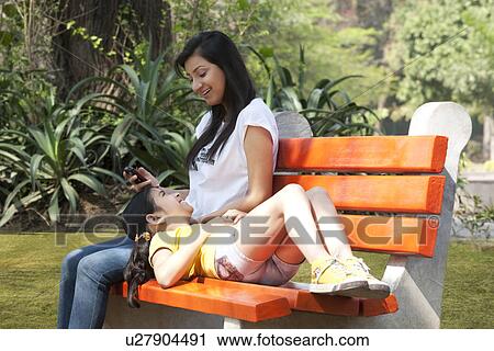 Daughter lying on her mothers lap View Large Photo Image Stock Image - Daughter lying on her mothers lap . Fotosearch