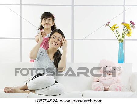 Picture - Daughter playing with her mother . Fotosearch