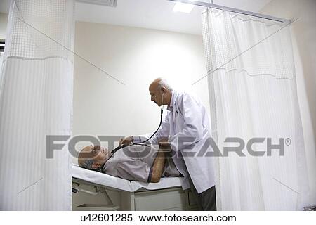 Stock Photography - Doctor checking a patient's heartbeat . Fotosearch