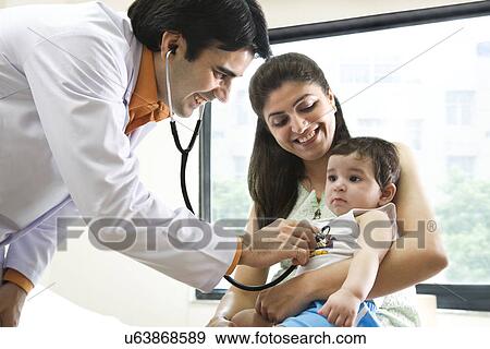 Stock Photo - Doctor checking the heartbeat of a baby . Fotosearch