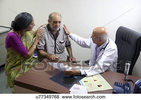 Doctor consoling his patient View Large Photo Image Stock Photo - Doctor consoling his patient . Fotosearch