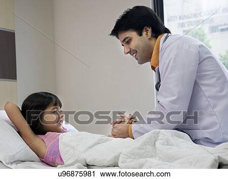 Doctor holding a little girl's hand View Large Photo Image Stock Image - Doctor holding a little girl's hand . Fotosearch