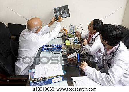 Doctor showing an X-ray View Large Photo Image Stock Photo - Doctor showing an X-ray . Fotosearch