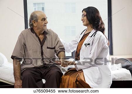 Stock Photography - Doctor sitting with her patient . Fotosearch