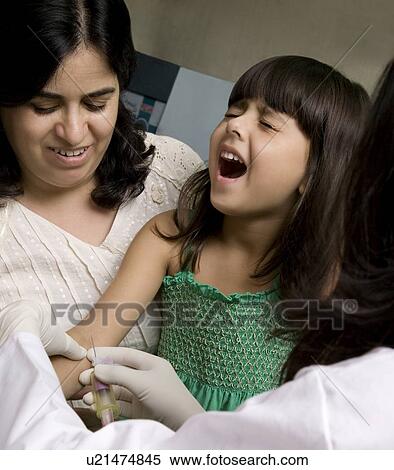 Doctor taking a blood sample from a girl View Large Photo Image Stock Photography - Doctor taking a blood sample from a girl . Fotosearch