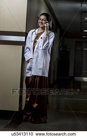 Stock Image - Doctor talking on a mobile phone . Fotosearch