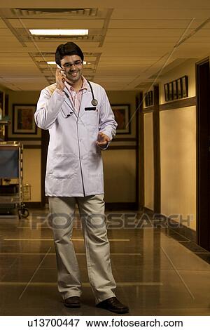 Doctor talking on a mobile phone View Large Photo Image Stock Photo - Doctor talking on a mobile phone . Fotosearch