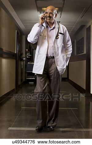 Stock Photograph - Doctor talking on a mobile phone . Fotosearch