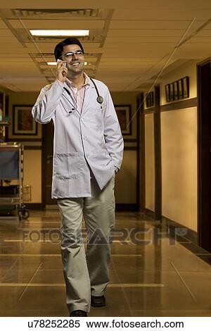 Stock Photography - Doctor talking on a mobile phone . Fotosearch