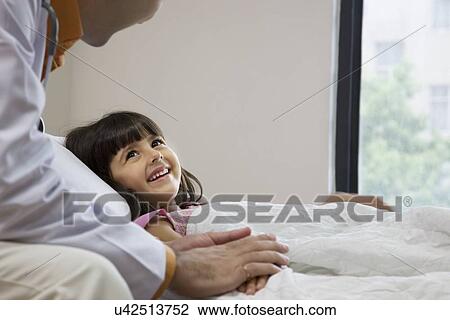 Doctor talking to a little girl View Large Photo Image Stock Image - Doctor talking to a little girl . Fotosearch