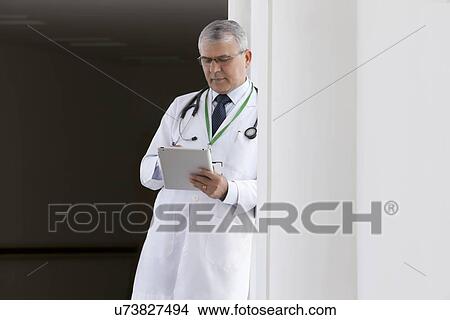 Doctor with a digital tablet View Large Photo Image Picture - Doctor with a digital tablet. Fotosearch