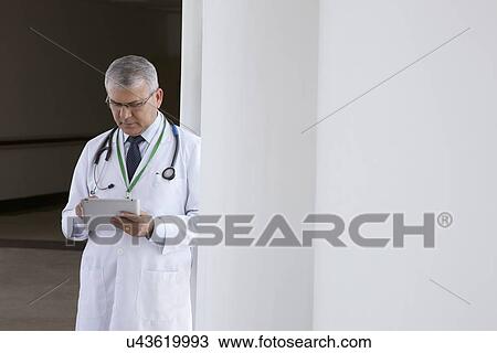 Doctor with a digital tablet View Large Photo Image Stock Image - Doctor with a digital tablet. Fotosearch