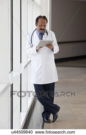 Doctor with a digital tablet View Large Photo Image Stock Image - Doctor with a digital tablet. Fotosearch