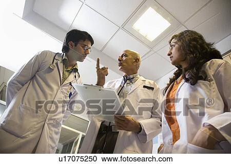 Stock Image - Doctors having a discussion . Fotosearch