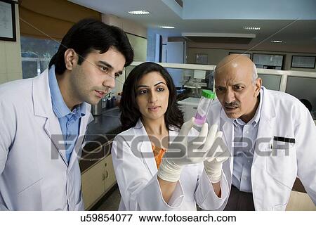 Doctors looking at a sample View Large Photo Image Stock Photo - Doctors looking at a sample . Fotosearch