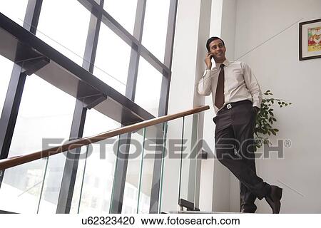 Stock Image - Executive talking on a mobile phone. Fotosearch
