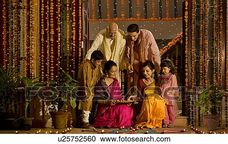 Family arranging diyas View Large Photo Image Stock Image - Family arranging diyas . Fotosearch