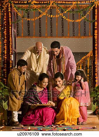 Family arranging diyas View Large Photo Image Stock Photo - Family arranging diyas . Fotosearch