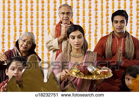 Family doing a pooja View Large Photo Image Stock Image - Family doing a pooja . Fotosearch