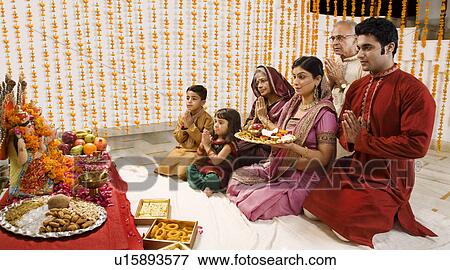Family doing a pooja View Large Photo Image Stock Photo - Family doing a pooja . Fotosearch